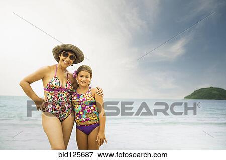 Stock Photo - Mother and daughter smiling on beach. Fotosearch