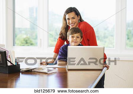 Stock Photo - Mother and son using laptop together. Fotosearch
