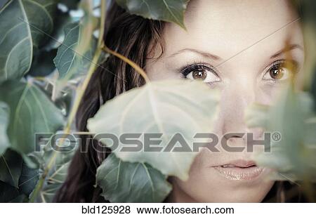 Native American woman peering through leaves View Large Photo Image Stock Photo - Native American woman peering through leaves. Fotosearch