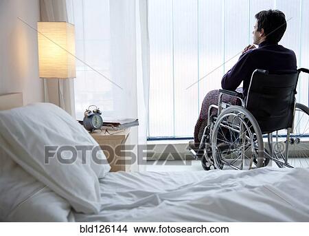 Pensive Caucasian man in wheelchair by window View Large Photo Image Picture - Pensive Caucasian man in wheelchair by window. Fotosearch