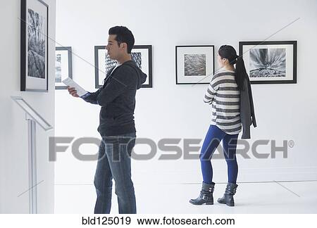 People admiring photograph art in gallery View Large Photo Image Stock Photo - People admiring photograph art in gallery. Fotosearch