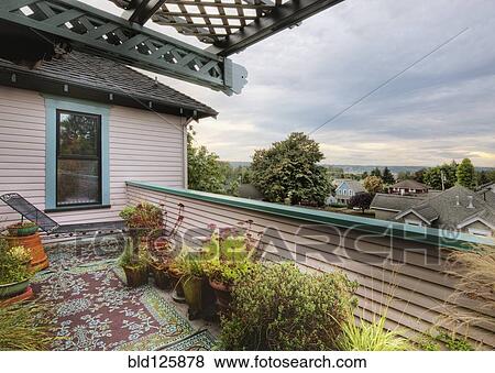 Stock Photo - Potted plants on balcony. Fotosearch