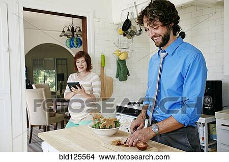 Pregnant Caucasian couple cooking in kitchen View Large Photo Image Picture - Pregnant Caucasian couple cooking in kitchen. Fotosearch
