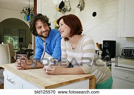 Pregnant Caucasian couple smiling in kitchen View Large Photo Image Stock Image - Pregnant Caucasian couple smiling in kitchen. Fotosearch