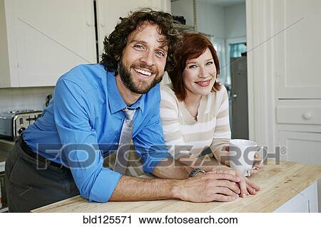 Pregnant Caucasian couple smiling in kitchen View Large Photo Image Stock Image - Pregnant Caucasian couple smiling in kitchen. Fotosearch