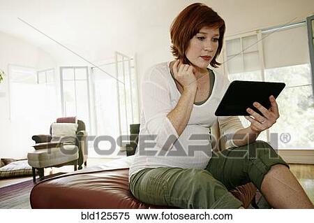Pregnant Caucasian woman using digital tablet View Large Photo Image Stock Photography - Pregnant Caucasian woman using digital tablet. Fotosearch