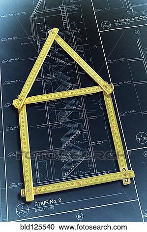 Rulers forming house over construction blueprints View Large Photo Image Stock Image - Rulers forming house over construction blueprints. Fotosearch