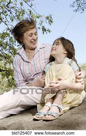 Stock Photo - Senior Caucasian woman and granddaughter in park. Fotosearch