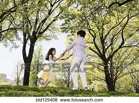 Senior Caucasian woman and granddaughter playing in park View Large Photo Image Stock Photo - Senior Caucasian woman and granddaughter playing in park. Fotosearch