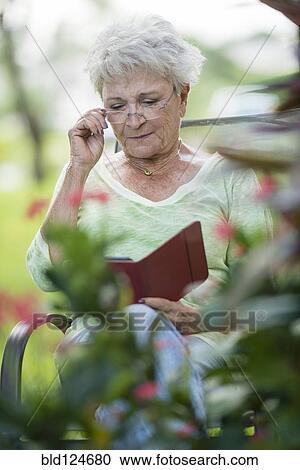 Stock Image - Senior Caucasian woman using digital tablet outdoors. Fotosearch