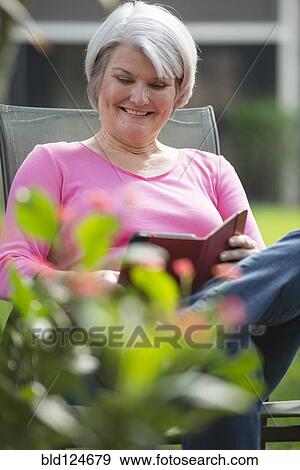 Stock Photo - Senior Caucasian woman using digital tablet outdoors. Fotosearch