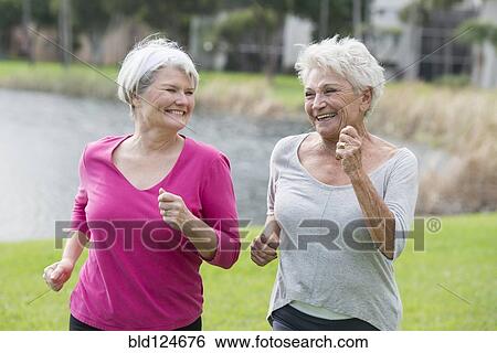 Senior Caucasian women jogging in park View Large Photo Image Stock Photograph - Senior Caucasian women jogging in park. Fotosearch