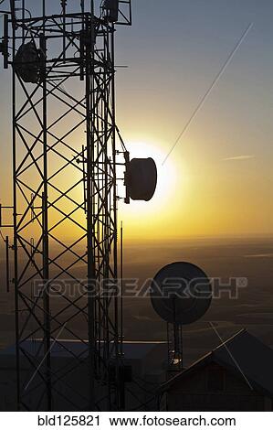 Silhouette of communications tower against sunset sky View Large Photo Image Stock Image - Silhouette of communications tower against sunset sky. Fotosearch