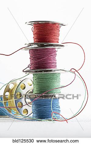Stacks of spools of multicolor thread View Large Photo Image Stock Image - Stacks of spools of multicolor thread. Fotosearch