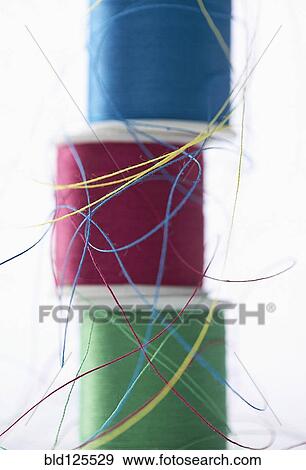 Stacks of spools of multicolor thread View Large Photo Image Stock Photo - Stacks of spools of multicolor thread. Fotosearch