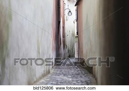 Streetlights hanging in alley View Large Photo Image Stock Photograph - Streetlights hanging in alley. Fotosearch