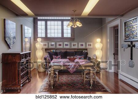 Stock Image - Table, drawers and sofa in living room. Fotosearch