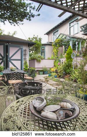 Stock Image - Tables and chairs in garden. Fotosearch