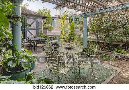 Tables and chairs on patio garden View Large Photo Image Stock Image - Tables and chairs on patio garden. Fotosearch