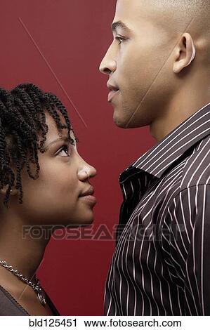 Stock Image - Woman looking up at boyfriend. Fotosearch