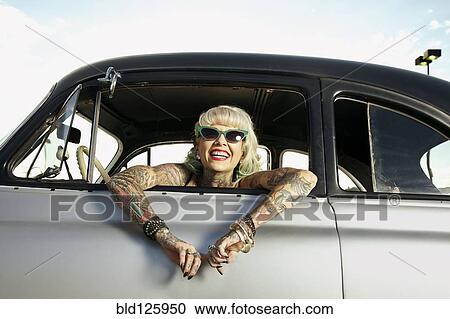 Woman with tattoos leaning out window of 1951 Chevy View Large Photo Image Stock Image - Woman with tattoos leaning out window of 1951 Chevy. Fotosearch