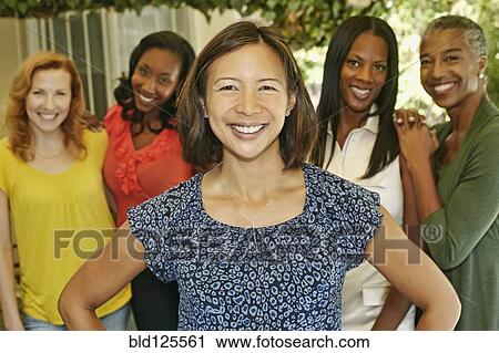 Women smiling together on patio View Large Photo Image Stock Image - Women smiling together on patio. Fotosearch