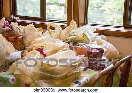 Bags of groceries on dining room table View Large Photo Image Stock Photography - Bags of groceries on dining room table. Fotosearch