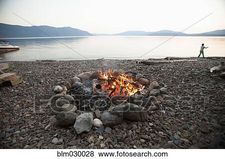 Bonfire on rocky beach View Large Photo Image Stock Photo - Bonfire on rocky beach. Fotosearch