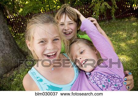 Stock Photo - Caucasian children playing in backyard. Fotosearch