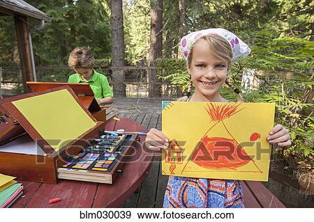 Stock Photo - Caucasian girl showing off drawing. Fotosearch