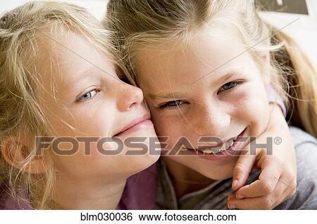 Stock Photograph - Caucasian girls hugging. Fotosearch