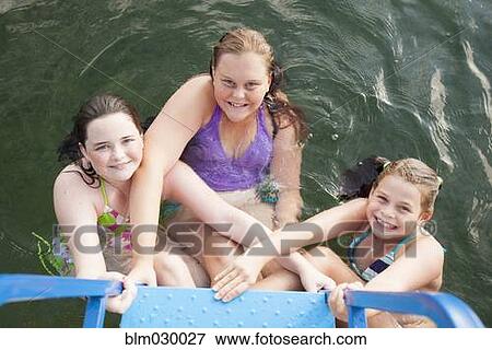 Caucasian girls swimming in lake View Large Photo Image Stock Photo - Caucasian girls swimming in lake. Fotosearch