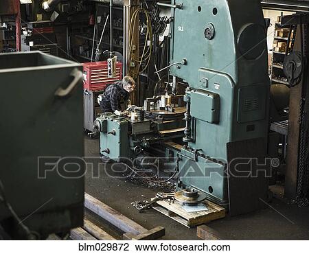 Caucasian man using machinery in workshop View Large Photo Image Stock Image - Caucasian man using machinery in workshop. Fotosearch