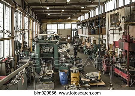Caucasian man walking through metal shop View Large Photo Image Stock Photograph - Caucasian man walking through metal shop. Fotosearch