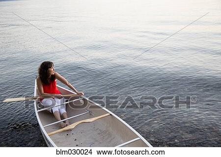 Caucasian woman sitting in canoe in lake View Large Photo Image Picture - Caucasian woman sitting in canoe in lake. Fotosearch