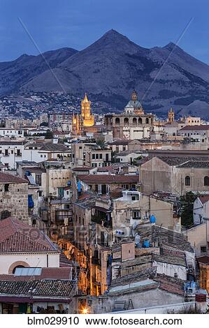 Stock Image - City below mountains at dusk, Palermo, Sicily, Italy. Fotosearch