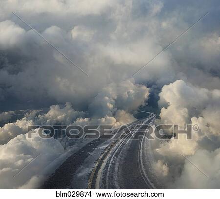 Picture - Clouds surrounding winding highway. Fotosearch