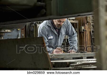 Man working in metal shop View Large Photo Image Stock Photo - Man working in metal shop. Fotosearch
