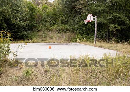 Stock Photograph - Overgrown basketball court. Fotosearch