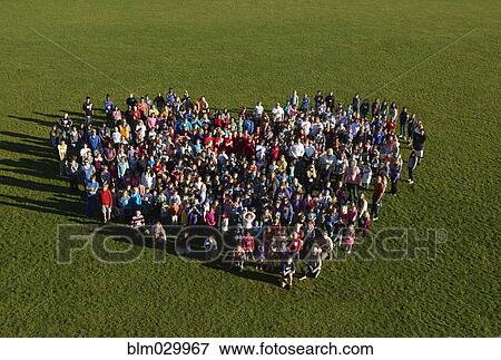 People forming heart-shape in park View Large Photo Image Stock Photo - People forming heart-shape in park. Fotosearch