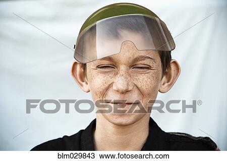 Stock Image - Portrait of Caucasian boy with freckles making a face. Fotosearch