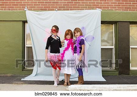 Stock Photography - Portrait of Caucasian girls in costumes outdoors. Fotosearch