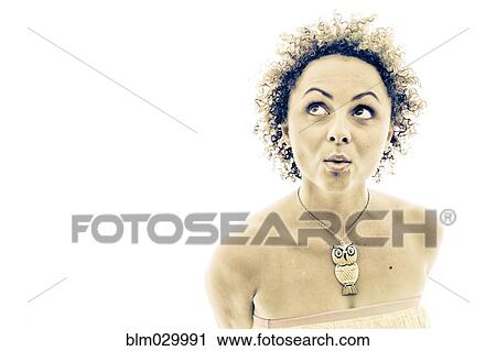 Stock Image - Portrait of curious woman wearing owl necklace. Fotosearch