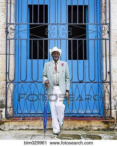 Portrait of well-dressed Black man in front of gated door View Large Photo Image Stock Image - Portrait of well-dressed Black man in front of gated door. Fotosearch