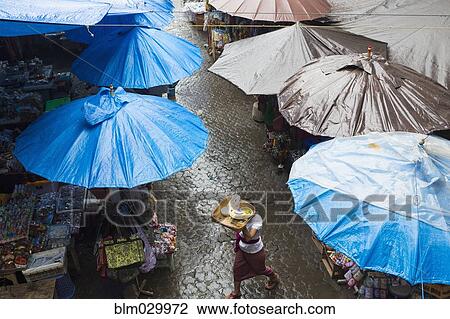 Rain falling over tarps and awnings of market stalls, Ubud, Bali, Indonesia View Large Photo Image Stock Image - Rain falling over tarps and awnings of market stalls, Ubud, Bali, Indonesia. Fotosearch