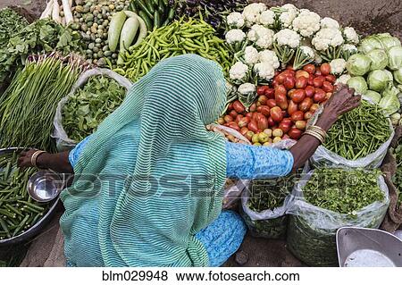Stock Photo - Vendor with vegetables at market, Jaisalmer, Rajasthan, India. Fotosearch
