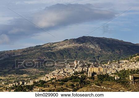 View of hillside town at sunset, Petralia Sottana, Sicily, Italy View Large Photo Image Stock Image - View of hillside town at sunset, Petralia Sottana, Sicily, Italy. Fotosearch