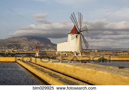 Windmill among salt flats, Trapani, Sicily, Italy View Large Photo Image Stock Photography - Windmill among salt flats, Trapani, Sicily, Italy. Fotosearch