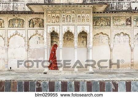 Stock Photography - Woman in sari walking through cloister, Pushkar, Rajasthan, India. Fotosearch