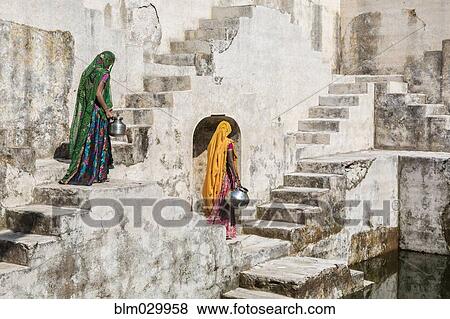 Stock Photo - Women in saris carrying water at step well, Jaipur, Rajasthan, India. Fotosearch